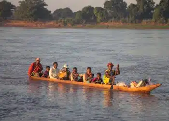 people riding on kayak on body of water during daytime