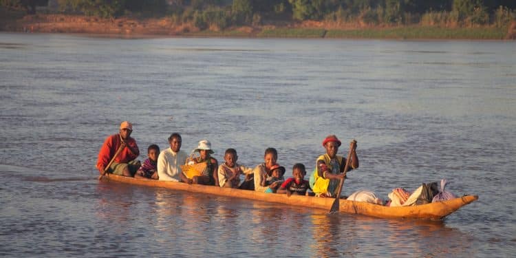 people riding on kayak on body of water during daytime