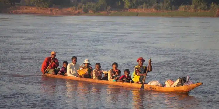 people riding on kayak on body of water during daytime